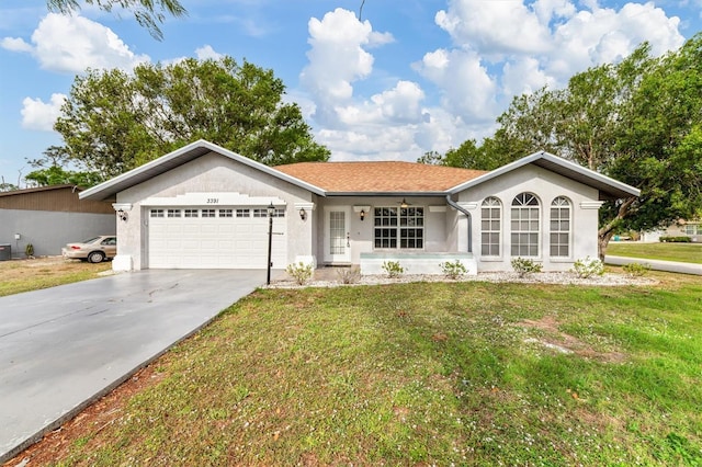 single story home with stucco siding, driveway, a front yard, and a garage