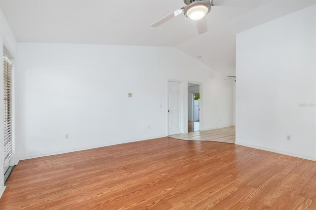 interior space featuring a ceiling fan, vaulted ceiling, and light wood-style floors