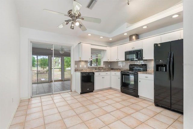 kitchen featuring visible vents, backsplash, black appliances, and vaulted ceiling