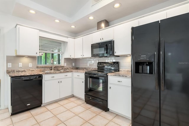 kitchen featuring white cabinetry, black appliances, and a sink