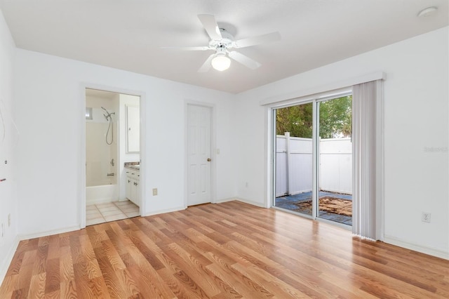 unfurnished bedroom with baseboards, ceiling fan, access to outside, light wood-type flooring, and connected bathroom