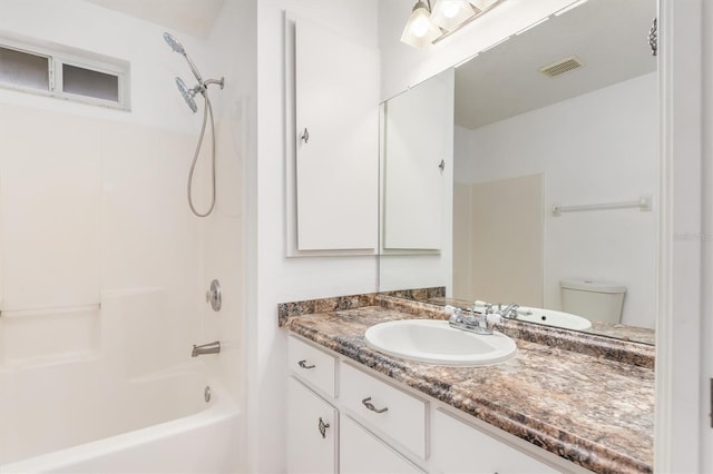 bathroom with tub / shower combination, visible vents, toilet, and vanity