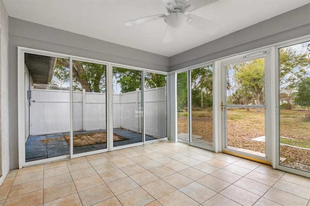 unfurnished sunroom with plenty of natural light and ceiling fan