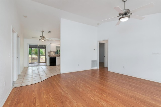 unfurnished living room with visible vents, high vaulted ceiling, a ceiling fan, and light wood finished floors