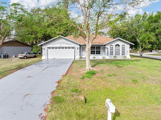 ranch-style house featuring driveway, an attached garage, central AC, stucco siding, and a front lawn