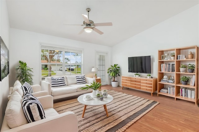 living room with lofted ceiling, wood finished floors, and ceiling fan