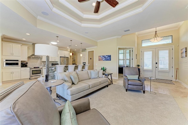 living room with ornamental molding, french doors, a raised ceiling, and visible vents