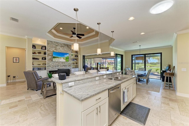 kitchen featuring built in shelves, stone tile floors, white cabinets, baseboards, and stainless steel dishwasher