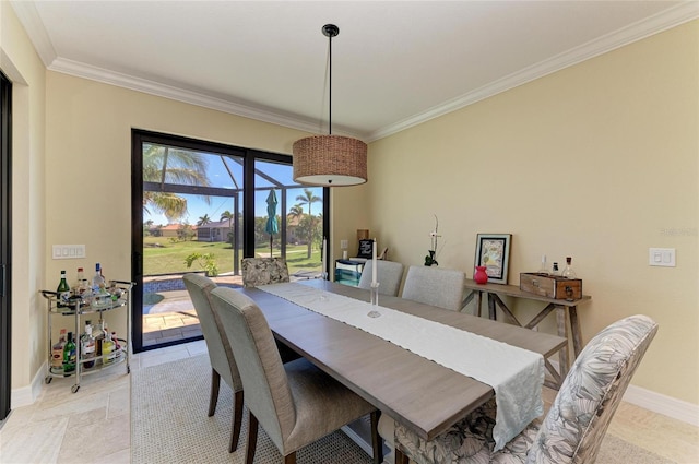 dining space featuring baseboards and ornamental molding