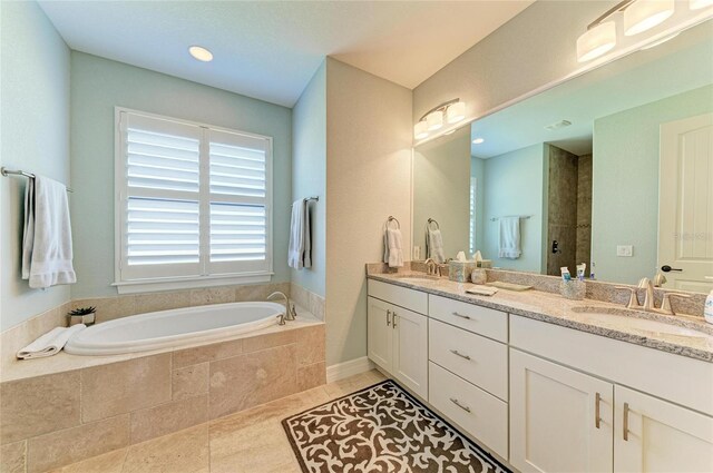 full bathroom with a garden tub, double vanity, a sink, and tile patterned floors