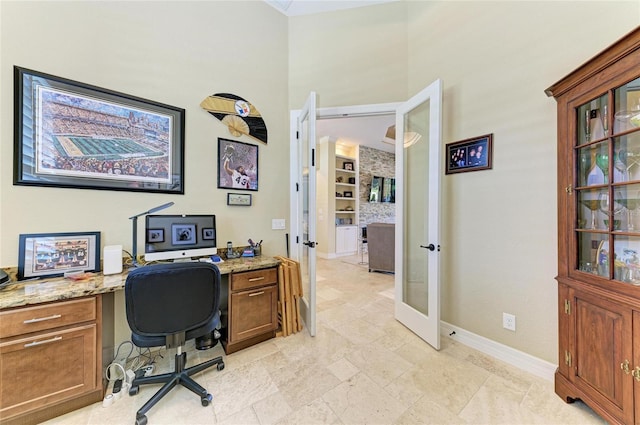 office featuring french doors, a towering ceiling, and baseboards