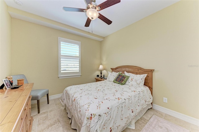 bedroom featuring a ceiling fan and baseboards