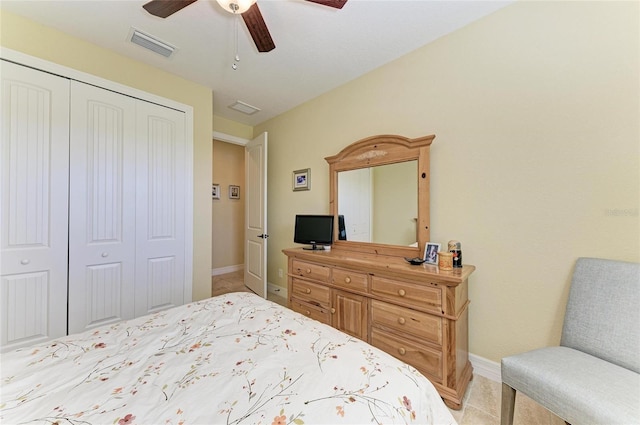 bedroom featuring baseboards, ceiling fan, visible vents, and a closet