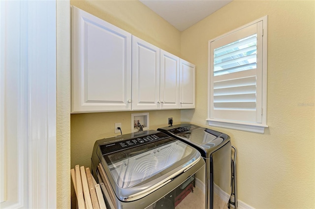 laundry area with cabinet space, baseboards, and separate washer and dryer