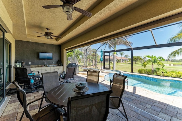 view of patio featuring glass enclosure, a pool with connected hot tub, a ceiling fan, and outdoor dining space