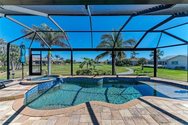 view of swimming pool with glass enclosure, a pool with connected hot tub, a patio area, and a yard