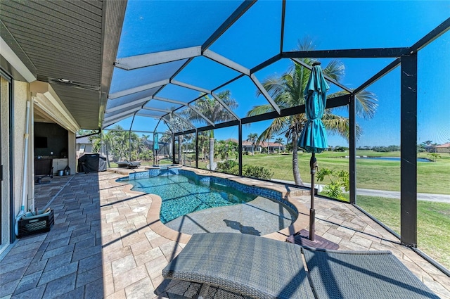 view of pool featuring a lanai, a patio area, and a lawn