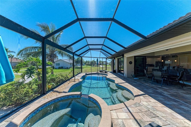 view of swimming pool featuring a pool with connected hot tub, a patio, and a lanai