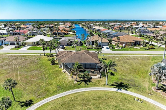 drone / aerial view featuring a water view and a residential view