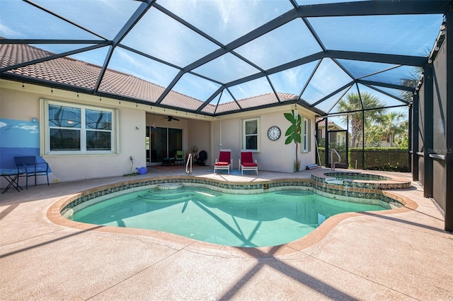 view of swimming pool with a ceiling fan, a lanai, a patio area, and a pool with connected hot tub