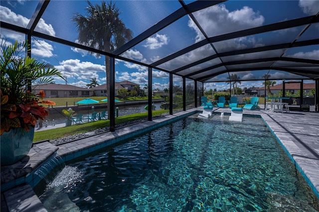 pool featuring a patio area and glass enclosure