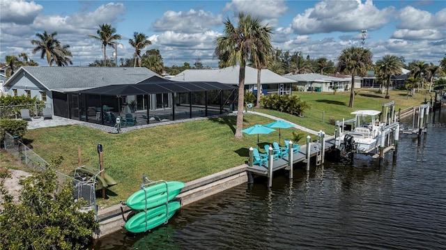 dock area featuring glass enclosure, a lawn, a water view, and boat lift