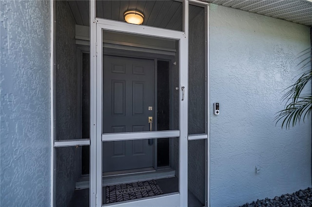 129 Barre Dr NW, Port Charlotte, FL 33952 - view of exterior entry featuring stucco siding