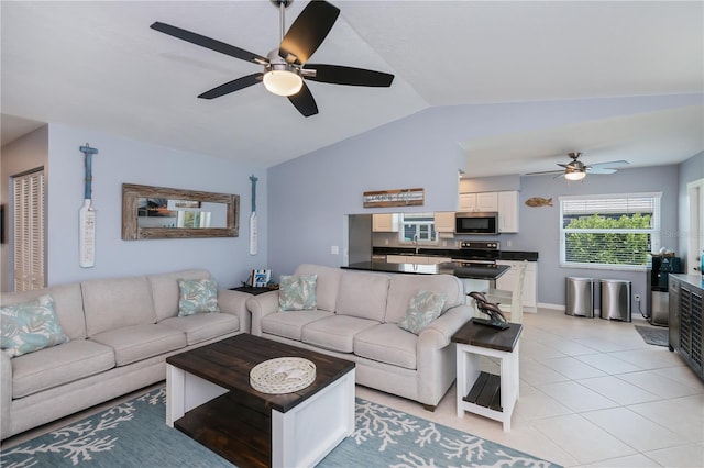 129 Barre Dr NW, Port Charlotte, FL 33952 - living area featuring light tile patterned floors, ceiling fan, and lofted ceiling