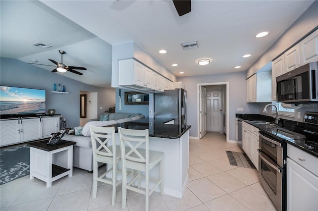129 Barre Dr NW, Port Charlotte, FL 33952 - kitchen with stainless steel appliances, a sink, visible vents, a ceiling fan, and open floor plan