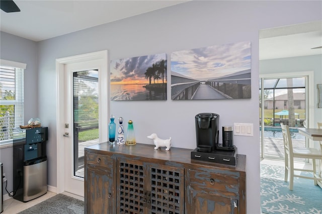 129 Barre Dr NW, Port Charlotte, FL 33952 - bar with light tile patterned floors, a dry bar, plenty of natural light, and baseboards