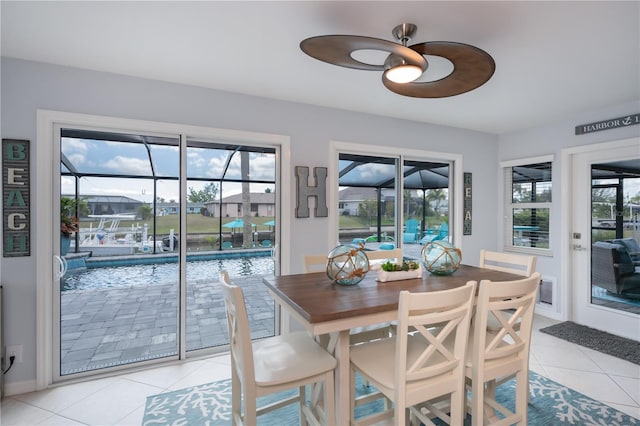 129 Barre Dr NW, Port Charlotte, FL 33952 - dining space featuring light tile patterned floors, ceiling fan, a sunroom, and baseboards