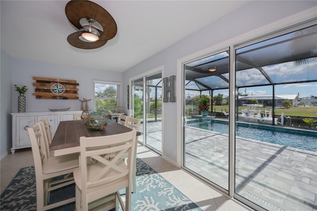 129 Barre Dr NW, Port Charlotte, FL 33952 - dining area featuring a sunroom, light tile patterned floors, and baseboards