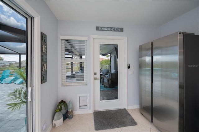 129 Barre Dr NW, Port Charlotte, FL 33952 - doorway with light tile patterned flooring and baseboards