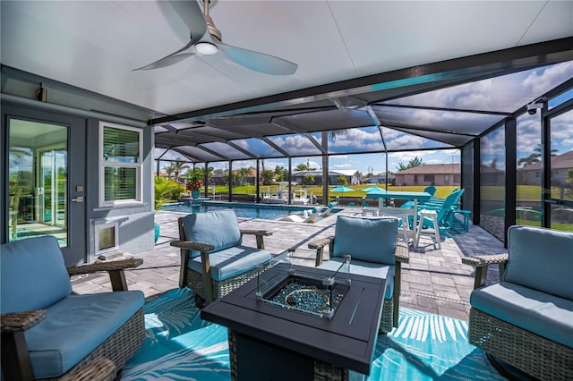 129 Barre Dr NW, Port Charlotte, FL 33952 - view of patio / terrace featuring glass enclosure, an outdoor living space with a fire pit, an outdoor pool, and ceiling fan