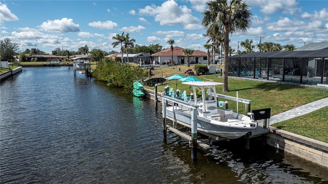 129 Barre Dr NW, Port Charlotte, FL 33952 - view of dock featuring boat lift, a residential view, a water view, a lanai, and a yard