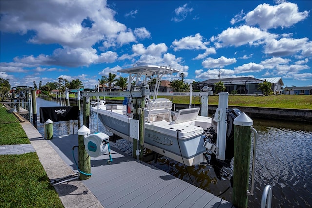 129 Barre Dr NW, Port Charlotte, FL 33952 - view of dock with a water view, a lawn, and boat lift