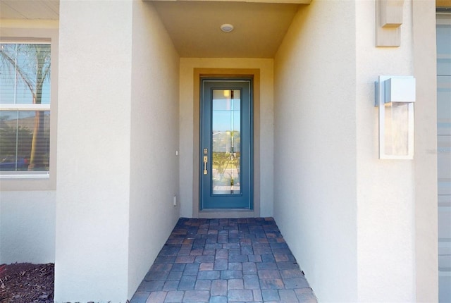 doorway to property with stucco siding