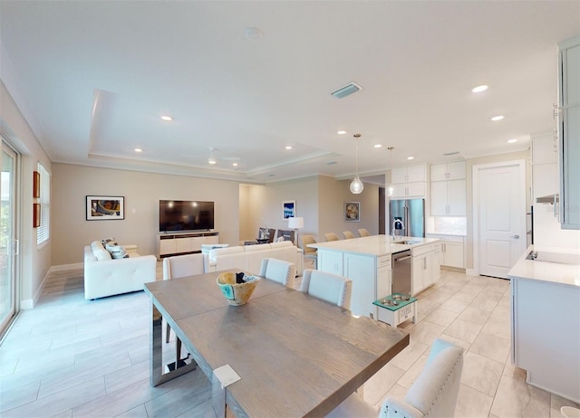 dining room with a tray ceiling, recessed lighting, visible vents, light tile patterned flooring, and baseboards