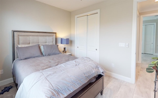 bedroom with baseboards and a closet