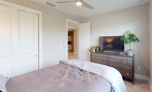 bedroom featuring a closet, visible vents, ceiling fan, and baseboards