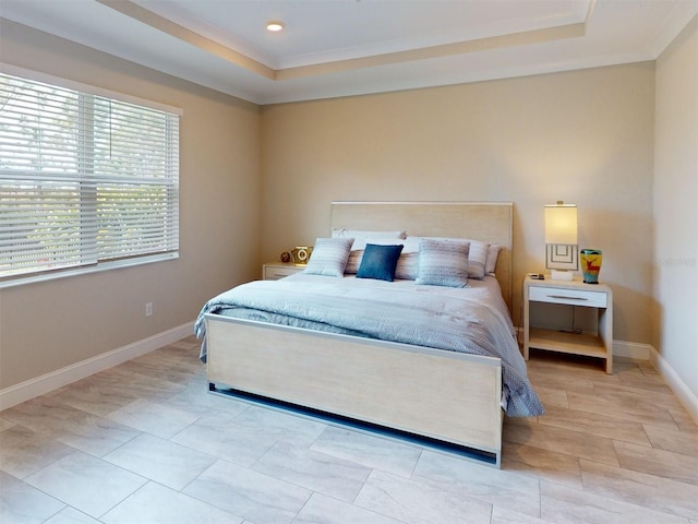 bedroom featuring ornamental molding, a tray ceiling, baseboards, and recessed lighting