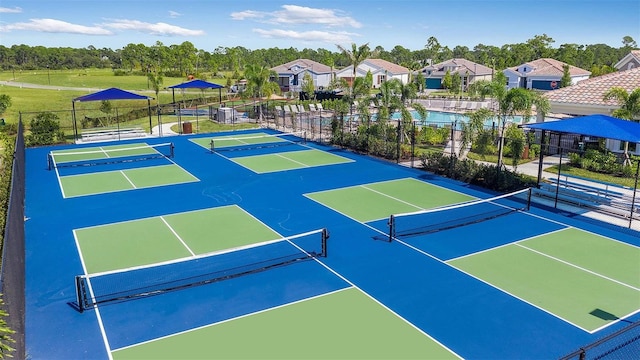 view of sport court featuring fence