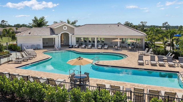 community pool featuring a patio area and fence