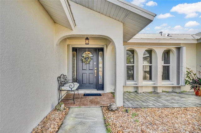 property entrance featuring stucco siding