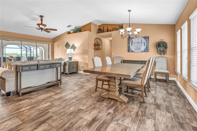 dining room with wood tiled floor, visible vents, vaulted ceiling, and a wealth of natural light