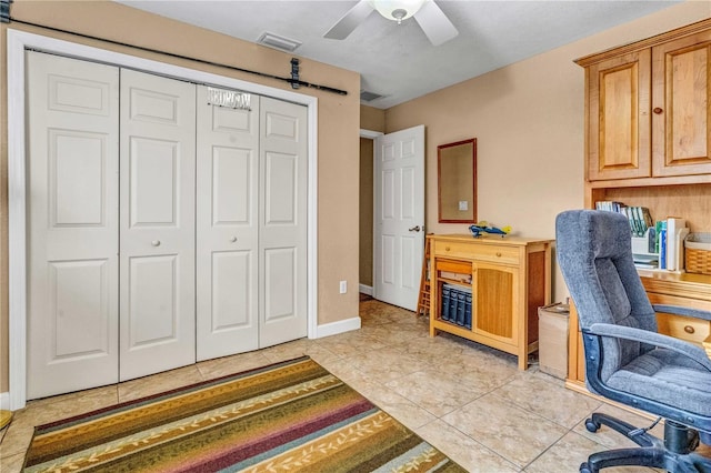 office area with light tile patterned floors, ceiling fan, visible vents, and baseboards