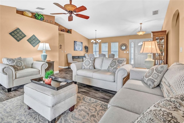 living area with visible vents, vaulted ceiling, dark wood-type flooring, and ceiling fan with notable chandelier