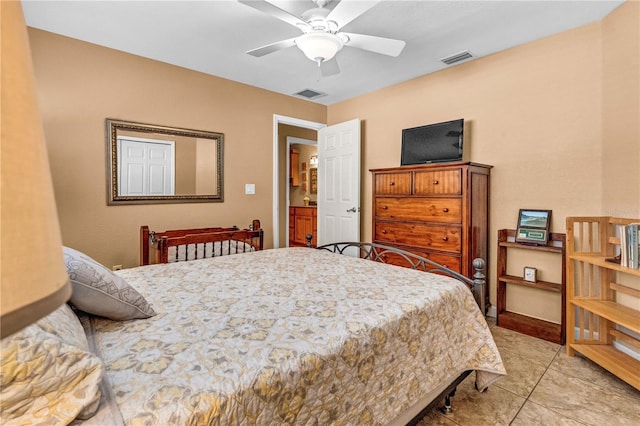 bedroom with a ceiling fan, visible vents, baseboards, and light tile patterned flooring