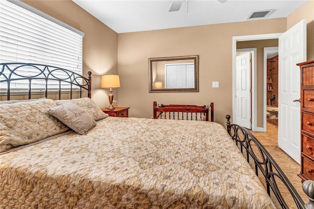 bedroom with light tile patterned floors, ceiling fan, and visible vents