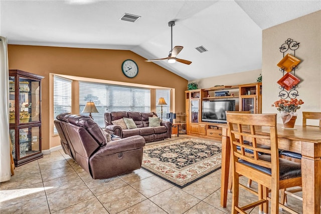 living area with vaulted ceiling, light tile patterned floors, visible vents, and a ceiling fan